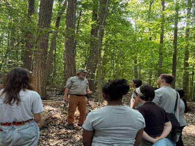 Students in forest on tour of Gordon Natural Area