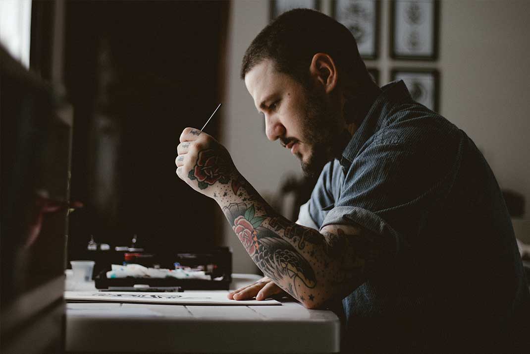Male Student drawing on canvas.