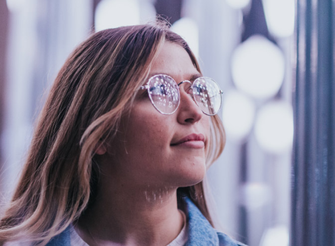 Student looking towards light - refelction in glasses.