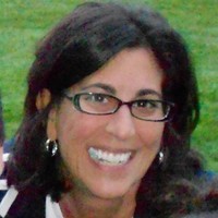 picture of woman in front of grass