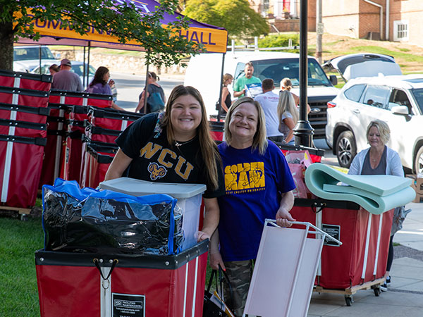 Student moving in with help from parent