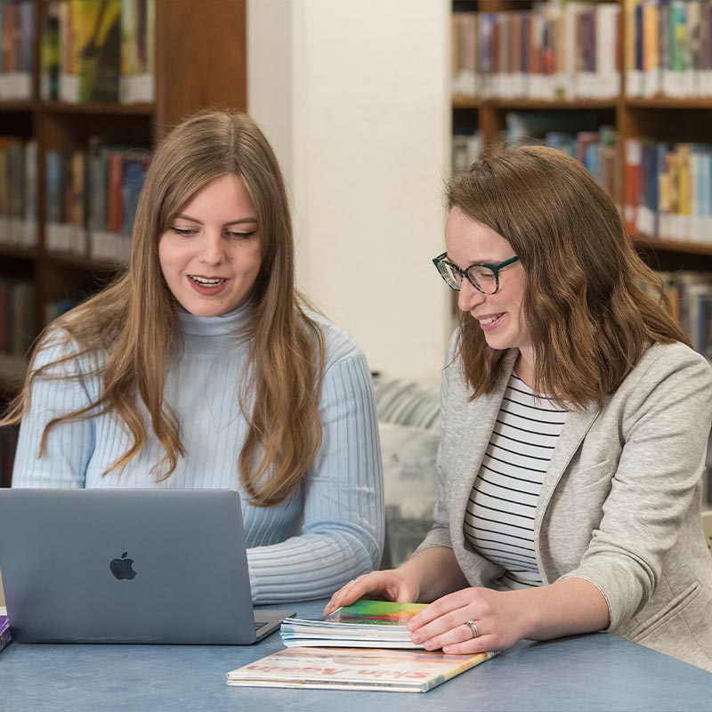 Students in Library on Laptop