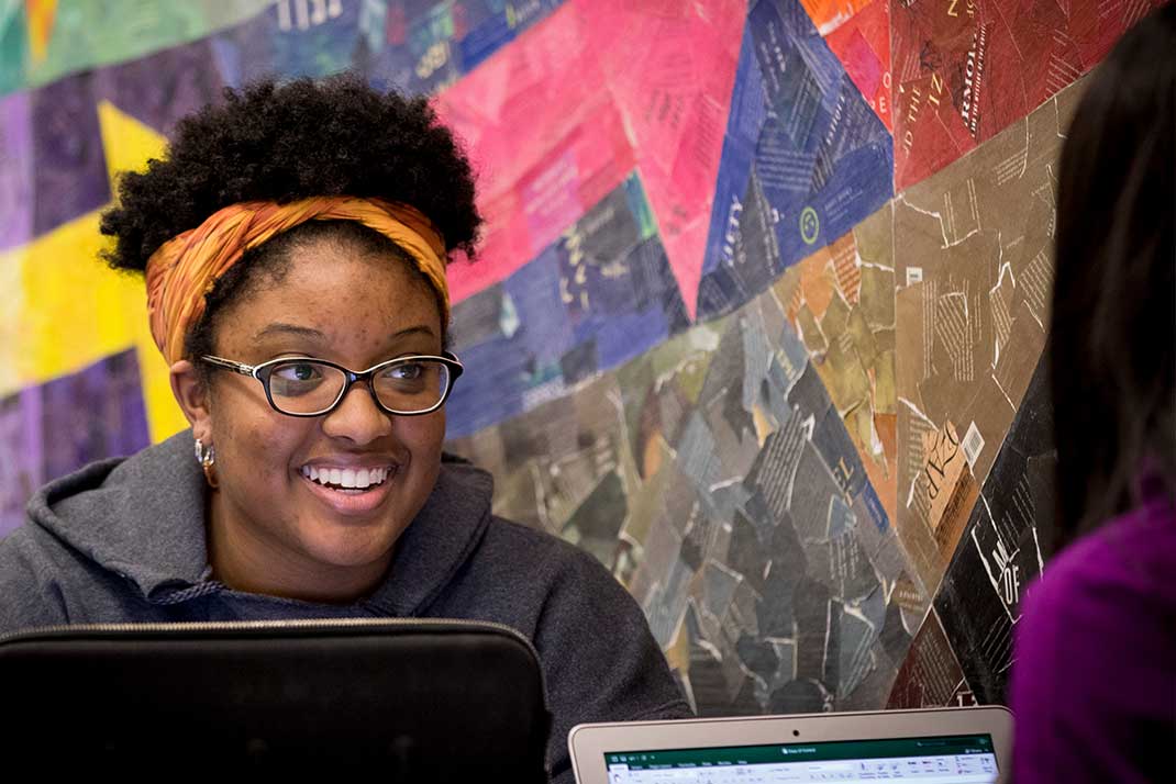 Student smiling with other student