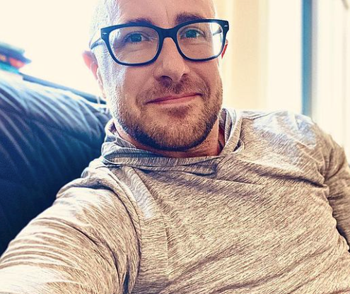 white man with glasses looking at camera