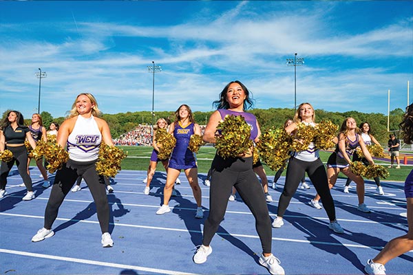 The WCU cheerleaders and Dance team are in the middle of a routine on the sidelines of the WCU homecoming game