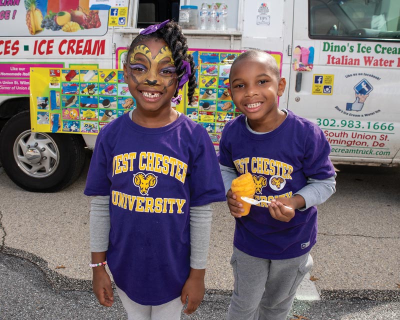 2 young kids with purple WCU tshirts; the little girl has ram face paint