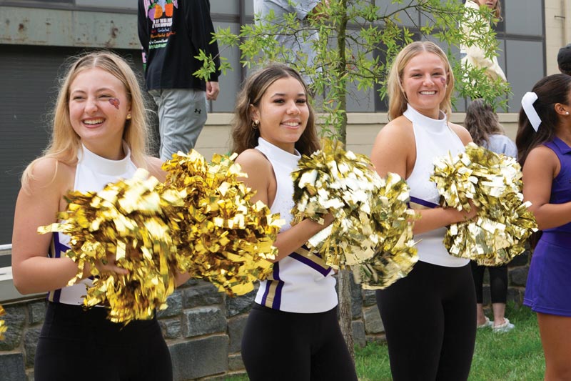 3 cheerleaders smile for the picture