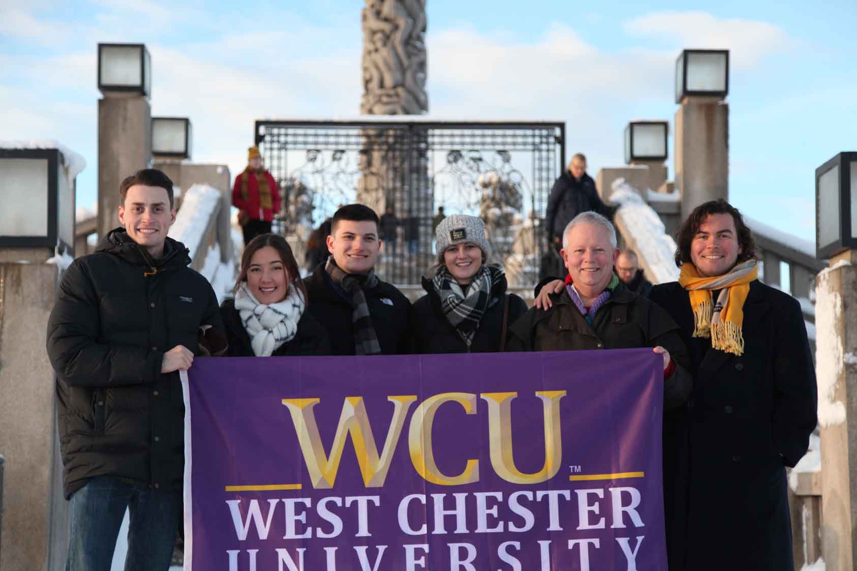 Group of 6 posing with WCU flag
