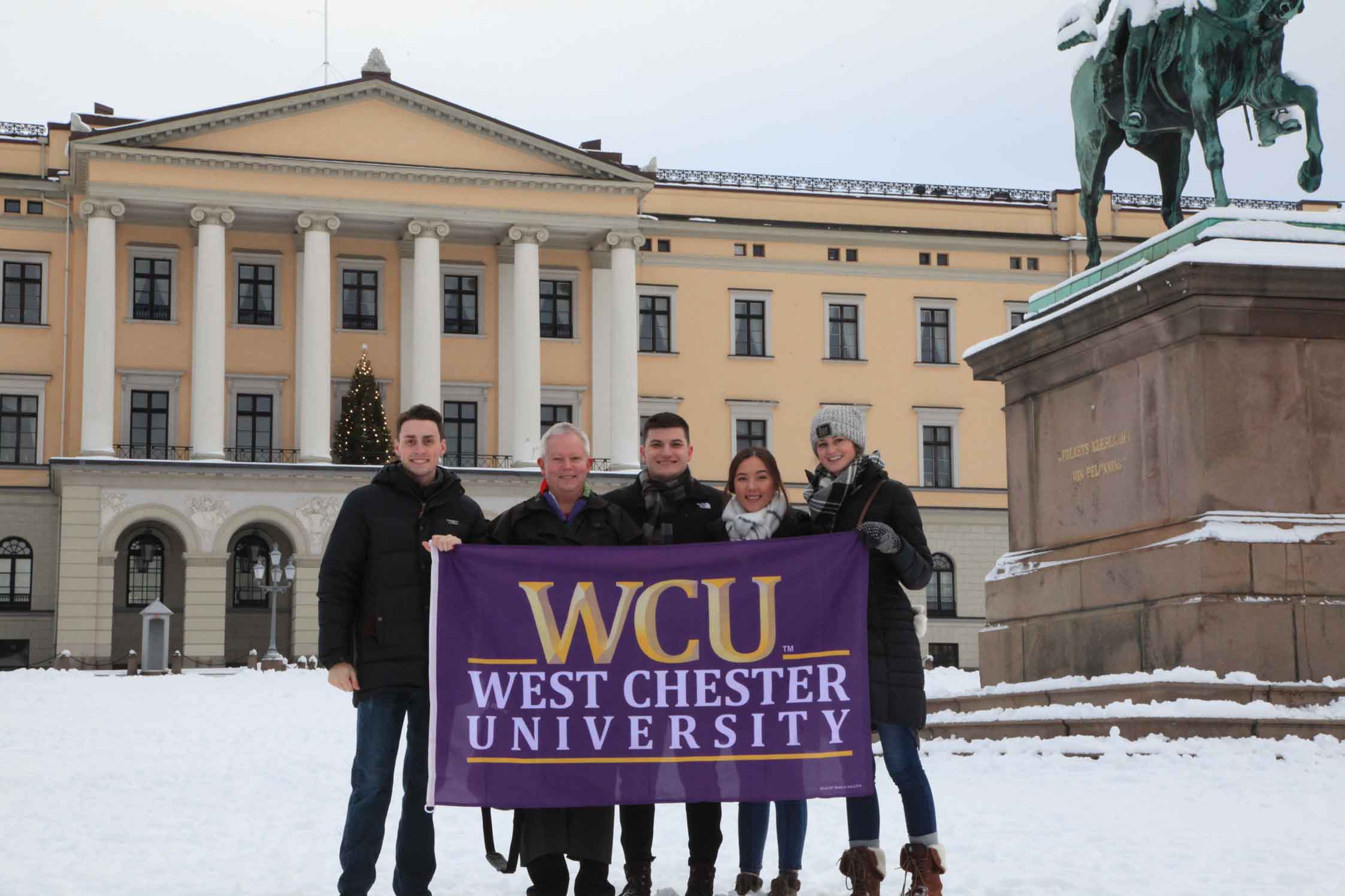 Group of 5 posing with WCU flag