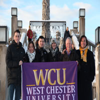 Group of 6 posing with WCU flag (Thumbnail)