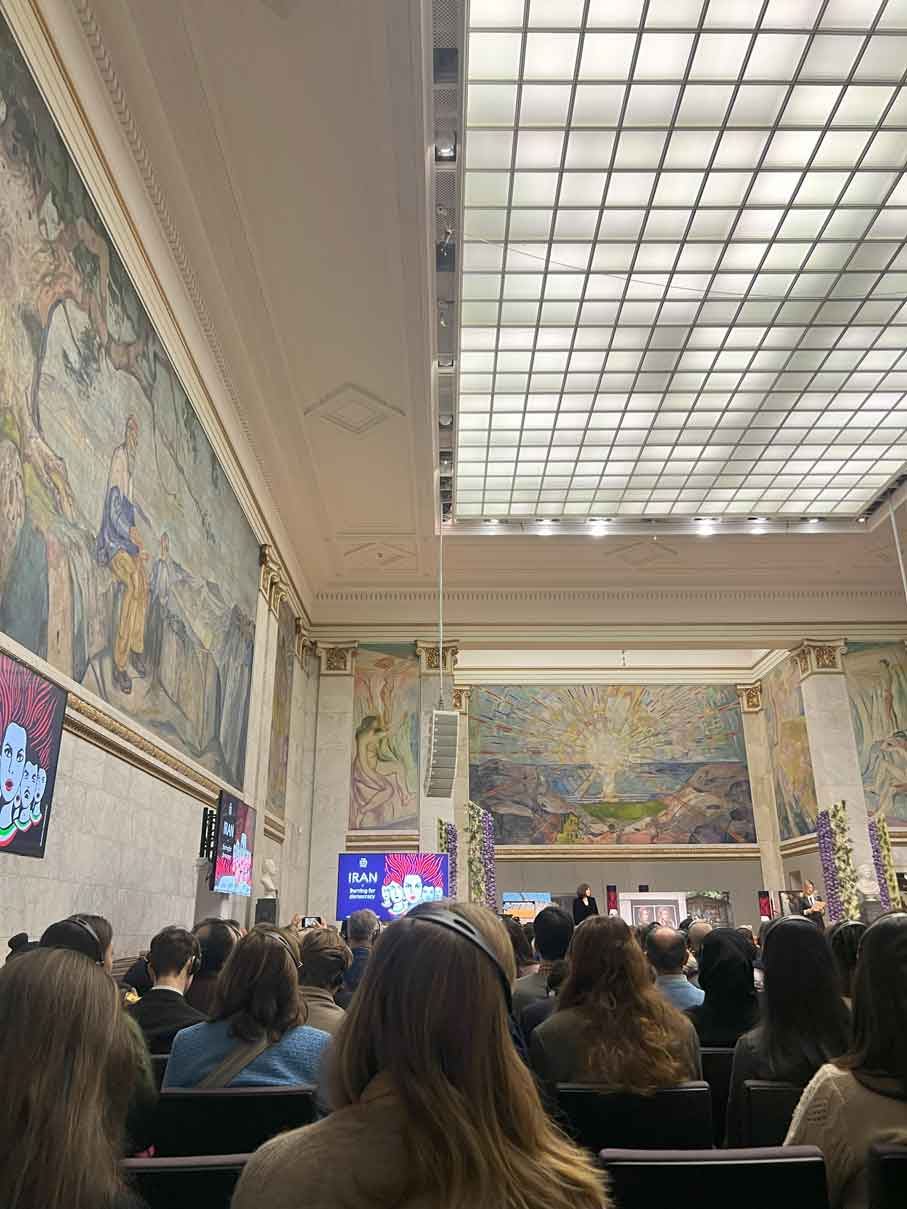 Inside musuem showing a promotional screen in the distance for IRAN.