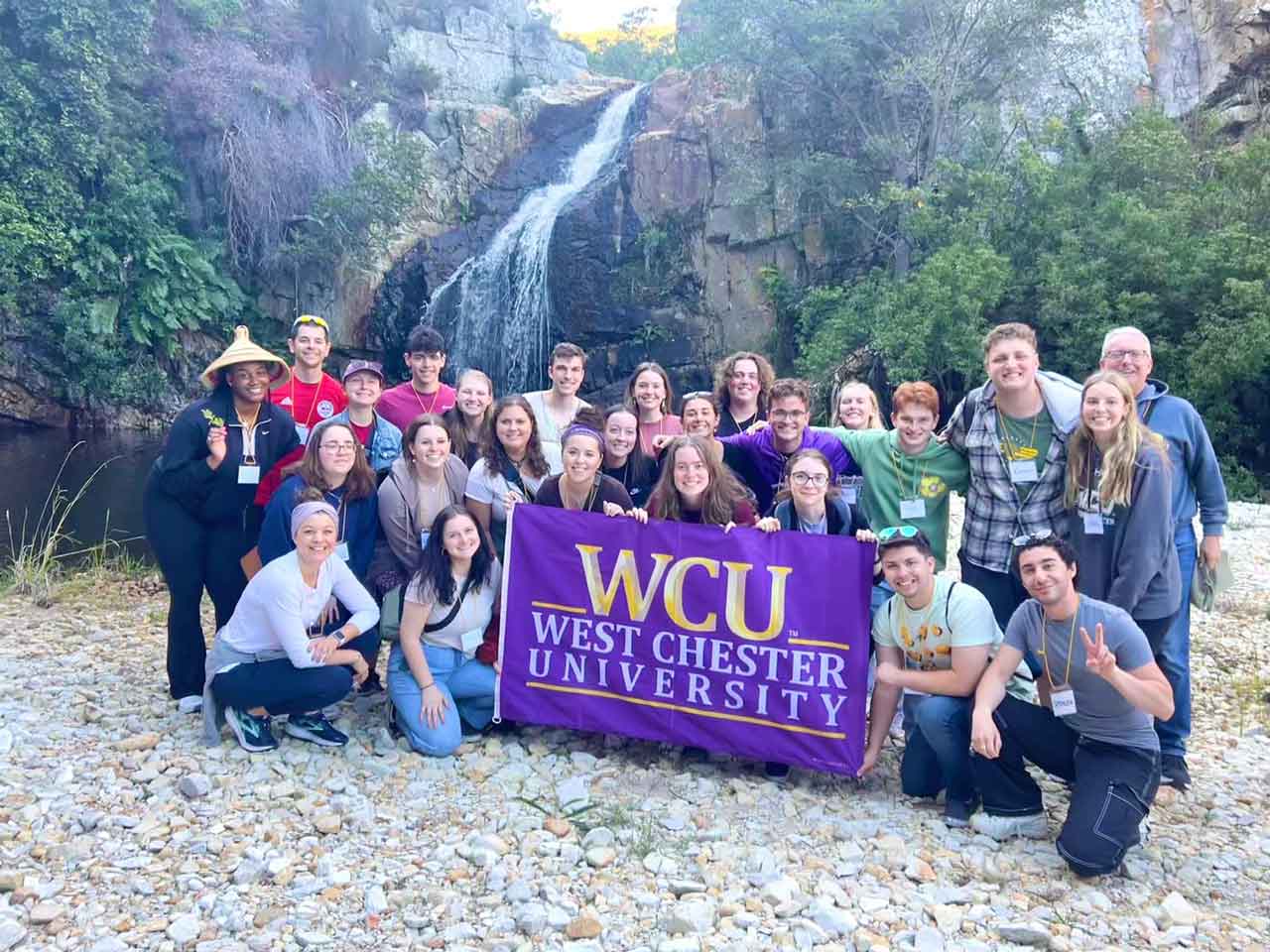 Group 1 posing in nature with the WCU flag