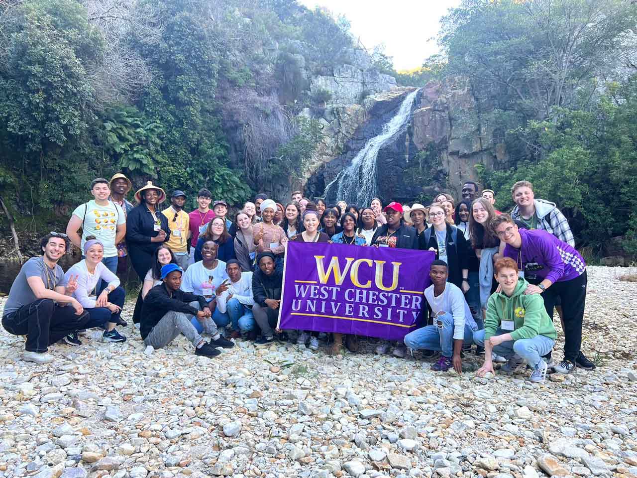 Group 2 posing in nature with the WCU flag