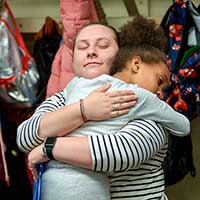 student hugging teacher