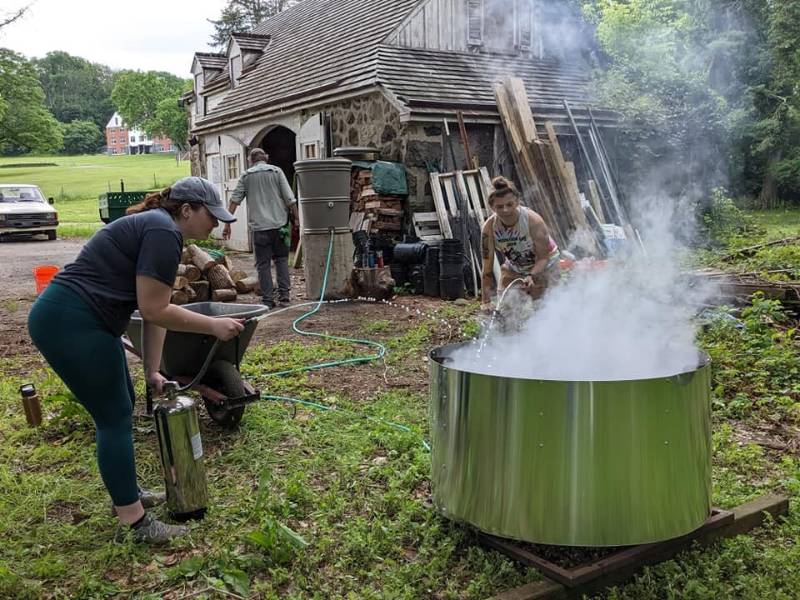 Student Interns Maeve Dowd (left) and Madison Rettnmaier 'top queching' the burn: the final step in the burn process