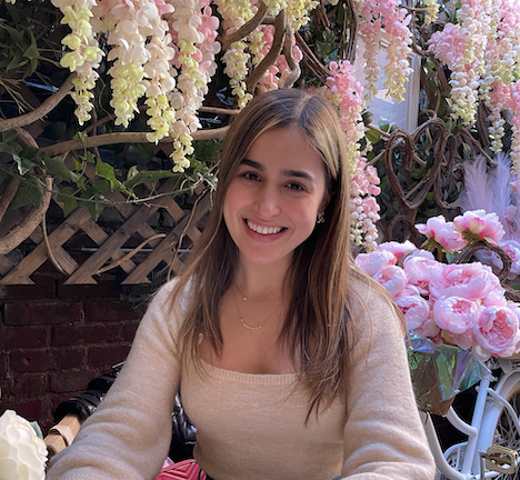 photo of alumna paula rubello surrounded by flowers