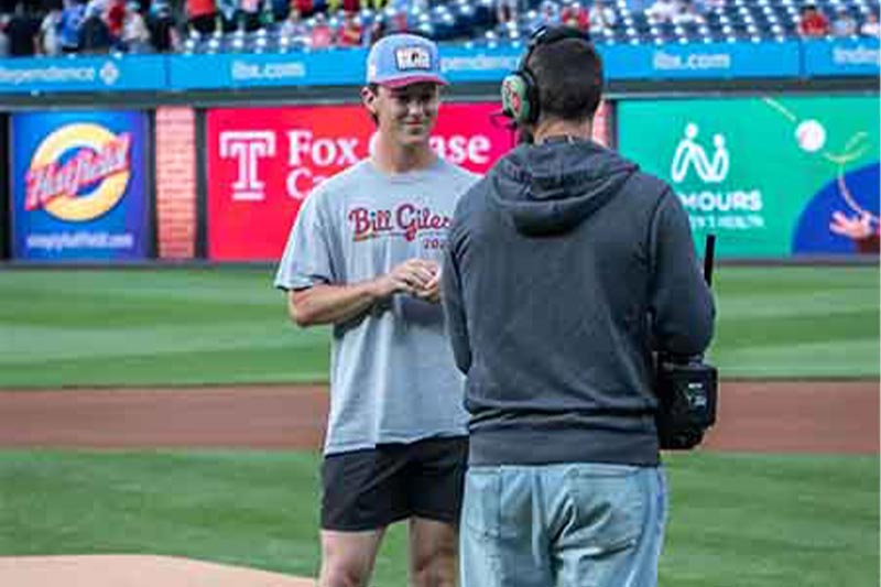 Thumbnail: Jake Welsch is talking to the cameraman before throwing the first pitch