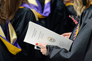 Graduate Holding Graduation Book