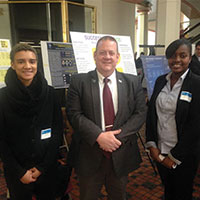 Students standing in front of posters