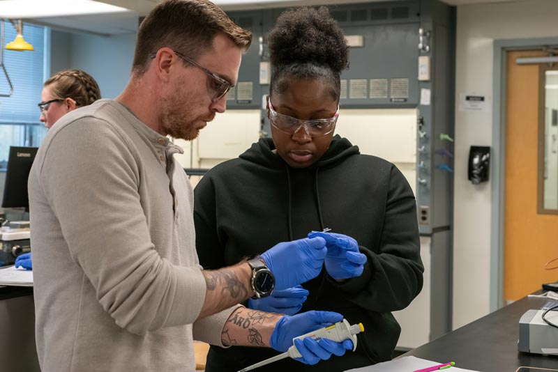 2 west chester university of PA chemistry students comparing a sample