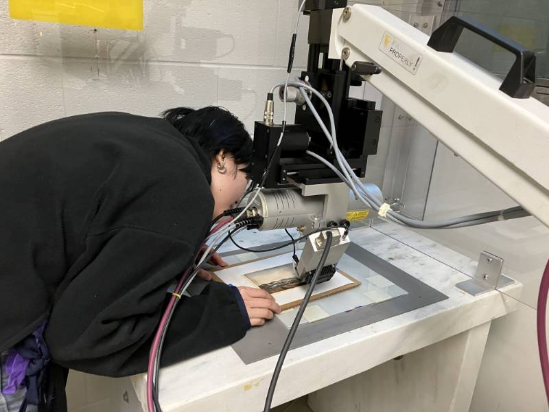 student uses chemistry equipment